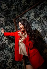 Blazer rojo de crepe elastizado, con solapas de muesca, corte recto y bolsillos laterales.