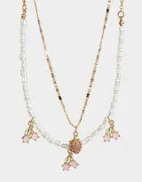 Collar corto multicadena dorado con una cadena de perlas y otra de eslabones, con dijes de cerezas y frutilla con strass.