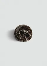 Broche con forma de flor roseta confeccionado en tejido satinado con estampado animal print.