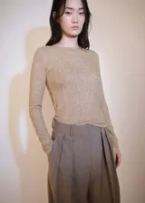 Camiseta de punto color beige con cuello redondo y mangas largas.
