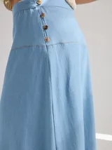 Falda midi color crudo de algodón, con pespuntes rojos a contratono y botones de coco en el lateral.