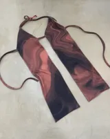 Top halter con estampado abstracto en tonos rosa y negro, con tiras finas para atar en el cuello y la espalda.