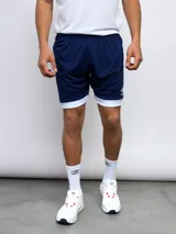 Short deportivo Umbro azul marino con cintura elástica y ribete blanco en el ruedo.