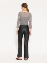 Pantalón de cuero ovino arrugado color gris, corte recto, con bolsillos delanteros y traseros, cierre metálico y tajos laterales en el ruedo.