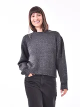 Buzo de tejido gris oscuro, con cuello redondo y diseño holgado.