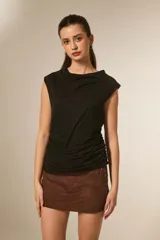 Musculosa negra de poliéster, ajustada al cuerpo, con cuello tipo buche drapeado y hombros anchos.