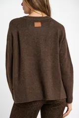 Sweater color marrón claro de tejido de punto, con cuello redondo y mangas largas.
