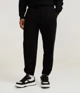 Pantalón jogger azul marino, de corte holgado con puños ajustados en los tobillos y cintura elástica con cordón.