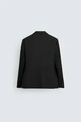 Blazer regular fit color negro confeccionada en tejido de lana. Cuello con solapas de muesca y manga larga acabada en puño con detalle de botones. Bolsillos de vivo en pecho y de solapa en cadera. Detalle de bolsillo interior. Bajo con aberturas en espalda. Cierre frontal de botonadura.