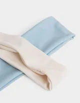 Set de dos vinchas elásticas de jersey, una color beige y otra celeste.