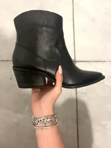 Botas bucaneras de cuero negro con puntera metálica y caña desmontable para transformarlas en botines.