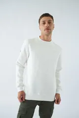 Buzo de algodón blanco con cuello redondo, manga larga y logo en relieve.
