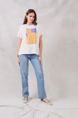 Remera blanca de corte holgado con estampado frontal de un recuadro violeta con la frase "Au jour d'hui!" en letras color naranja.
