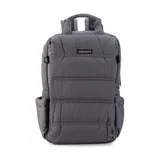 Mochila gris capitoneada con asa y correas regulables. Doble cierre principal, bolsillo al frente con apertura vertical y bolsillo trasero pequeño. Espacio para laptop de 15 pulgadas y correas ocultables.