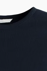 Remera azul marino de punto acanalado de algodón, corte entallado, cuello redondo y bajo recto.