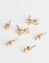 Set de tres pares de aros dorados con distintos diseños: un par con strass, un par con forma de esfera texturizada y un par con forma de oso.
