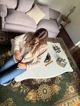 Blazer de jean azul con cuello, solapa y cuatro botones frontales. Presenta volados de encaje negro en cuello y delantero, mangas largas con pliegues y bolsillos plaqué. Interior con terminación en hilo bordó.