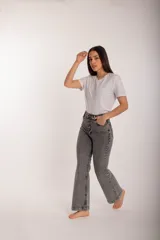 Pantalón gris de jean con corte acampanado, tiro alto y cierre frontal con botones.