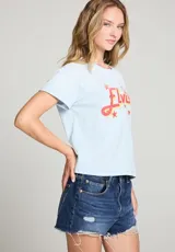 Remera celeste con estampa de la palabra "Elvis" en rojo y amarillo, con estrellas y un diseño de Sun Records.