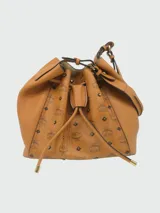 Cartera bombonera de cuero color camel con monograma estampado y tachas doradas.