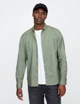 Camisa celeste a rayas verticales blancas, de corte clásico, con cuello abotonado y bolsillo en el pecho.