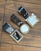 Cinto de ecocuero con hebilla redonda de alpaca y nácar.