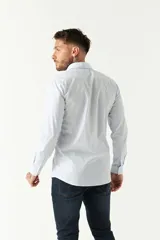 Camisa celeste a cuadros, de corte slim fit, manga larga y logo bordado. Confeccionada en 100% algodón.