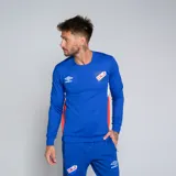 Buzo deportivo Umbro del Club Nacional de Football, modelo Premier, color azul marino con detalles en blanco en los puños y paneles laterales en rojo. Presenta el escudo del club en el pecho.