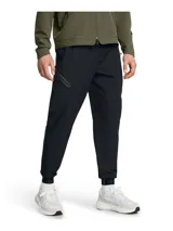 Pantalón deportivo Under Armour Unstoppable para hombre, color negro, de corte ajustado con puños elásticos en los tobillos y bolsillos laterales con cierre.