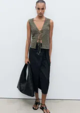 Top verde oliva de tejido texturizado, con cuello en V y cierre frontal con lazos.