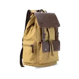 Mochila negra de tela canvas con detalles en símil cuero marrón, cierre superior marinero, bolsillos internos y externos con cierre metálico, asas rígidas y correas ajustables.