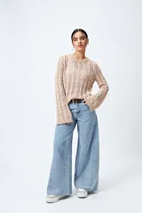 Sweater calado celeste con escote redondo y mangas largas acampanadas, tejido en punto fantasía con dibujo vertical.