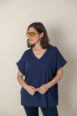 Remera holgada color beige, de escote en V y mangas cortas.