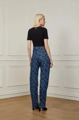 Pantalón de jean azul con estampado de la marca Animale Jeans en color blanco.