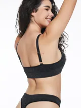 Top de bikini negro con textura brillante y breteles finos.