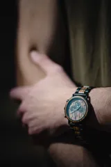 Reloj de pulsera Chenaut Aurum para hombre, con caja de acero inoxidable negra y esfera de madera de zebrano. La malla es de acero inoxidable negra con detalles en madera de bambú. Tiene cronógrafo, indicador de 24 horas y fechador.