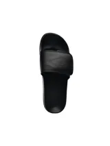 Ojotas blancas con logo Umbro negro en la tira.