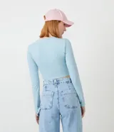 Blusa cropped celeste de algodón con cuello redondo y mangas largas.