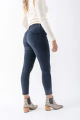 Pantalón de pana azul marino, tiro alto, corte skinny y pretina elastizada.