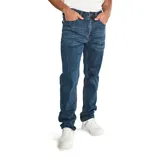 Jeans de hombre color azul medio lavado, corte slim a través de la pierna, con cierre de cremallera y botón con logo CAT. Presenta diseño de cinco bolsillos con remaches y parches con logo CAT.