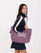Bolso shopper de lona rayada en tonos rosa y negro, con asas superiores y bordado frontal con la inscripción "Hyde Park Main Station Hyde Park Westminster".