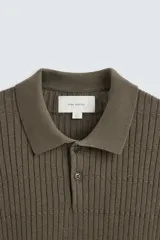 Polo color verde oliva de corte regular, tejido de punto con mezcla de algodón y cashmere. Tiene cuello solapa con cierre frontal de botonadura, manga larga y acabados en rib.