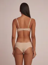 Pack de dos culottes de algodón color nude, con detalle de lazo pequeño en el centro frontal y borde superior con terminación de encaje o puntilla fina.