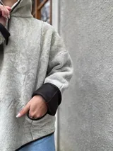 Buzo reversible de cuero color gris claro, con interior de corderito sintético.