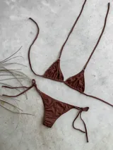 Bikini de triángulo color rojo, con top atable al cuello y espalda, y bottom vedetina de tiro bajo.