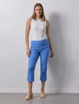 Pantalón capri azul de algodón. Delantera con bolsillos simulados, trasera con bolsillos aplicados. Pretina ancha elastizada, corte recto. Ruedo con aplique entrelazado, tachas y terminación desflecada.