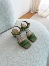 Sandalias de tacón bajo color verde pistacho, con tiras de gamuza y hebilla dorada.