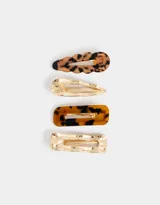 Set de cuatro hebillas para el pelo en acrílico con diferentes formas y estampados carey y dorado.