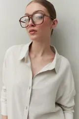 Vestido camisero corto negro de lino con botones tipo mostacillas y cinturón estampado.