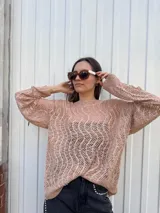 Sweater de punto calado color rosa, de corte holgado y mangas largas abullonadas.